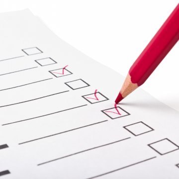 background check service verispy cost pricing checking boxes on paper with a red pencil